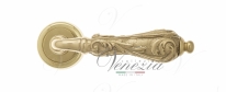 Ручка дверная на круглой розетке Venezia Monte Cristo D1 Латунь блестящая