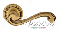 Ручка дверная на круглой розетке Venezia Vivaldi D3 Золото французское + коричневый